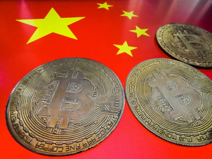 Bruised by stock market, China rushes into banned bitcoin - The Japan Times